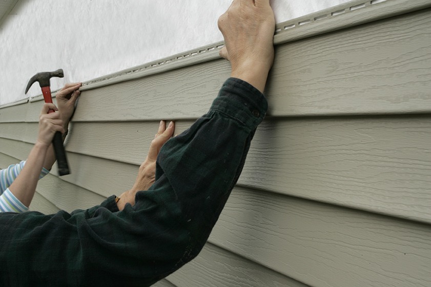 Installing Siding on a House 2 men fixing house siding