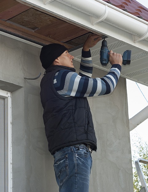 man fixing soffit