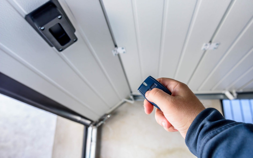 man's hand pointing at garage door trying to do troubleshooting