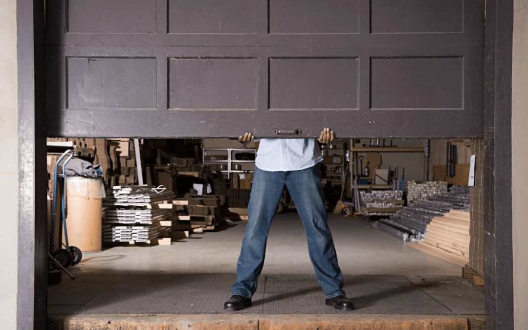 man lifting up old garage door ready to replace garage doors columbia mo