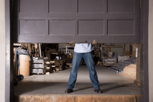 man lifting up old garage door ready to replace garage doors columbia mo