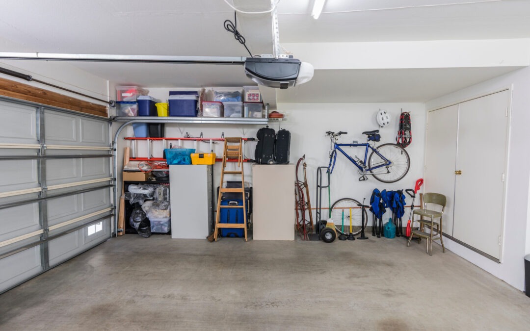 Organized clean residential two car garage with tools, file cabinets and sports equipment without garage door insulation installed.
