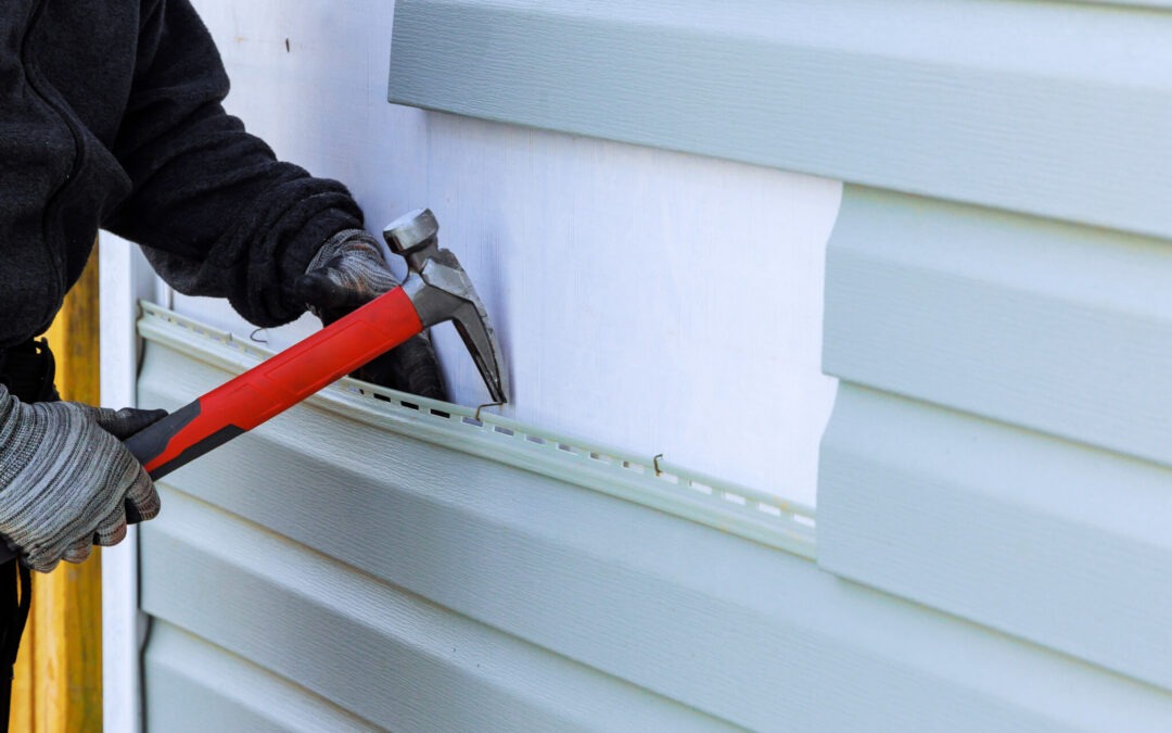 As part of an exterior house renovation, loose siding is being replaced